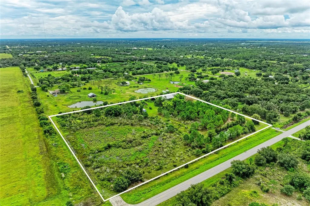 Aerial listing photo of wooded acreage at 6905 County Road 675 with approximate property outline